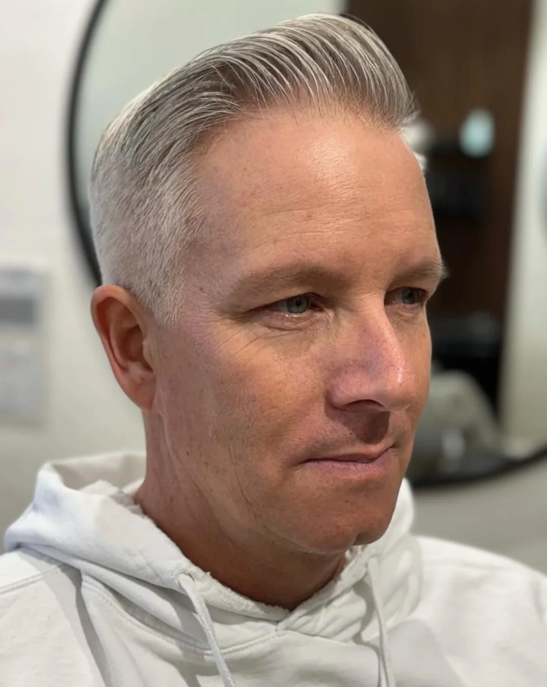 Finished men's haircut — blond textured cut with a full red beard